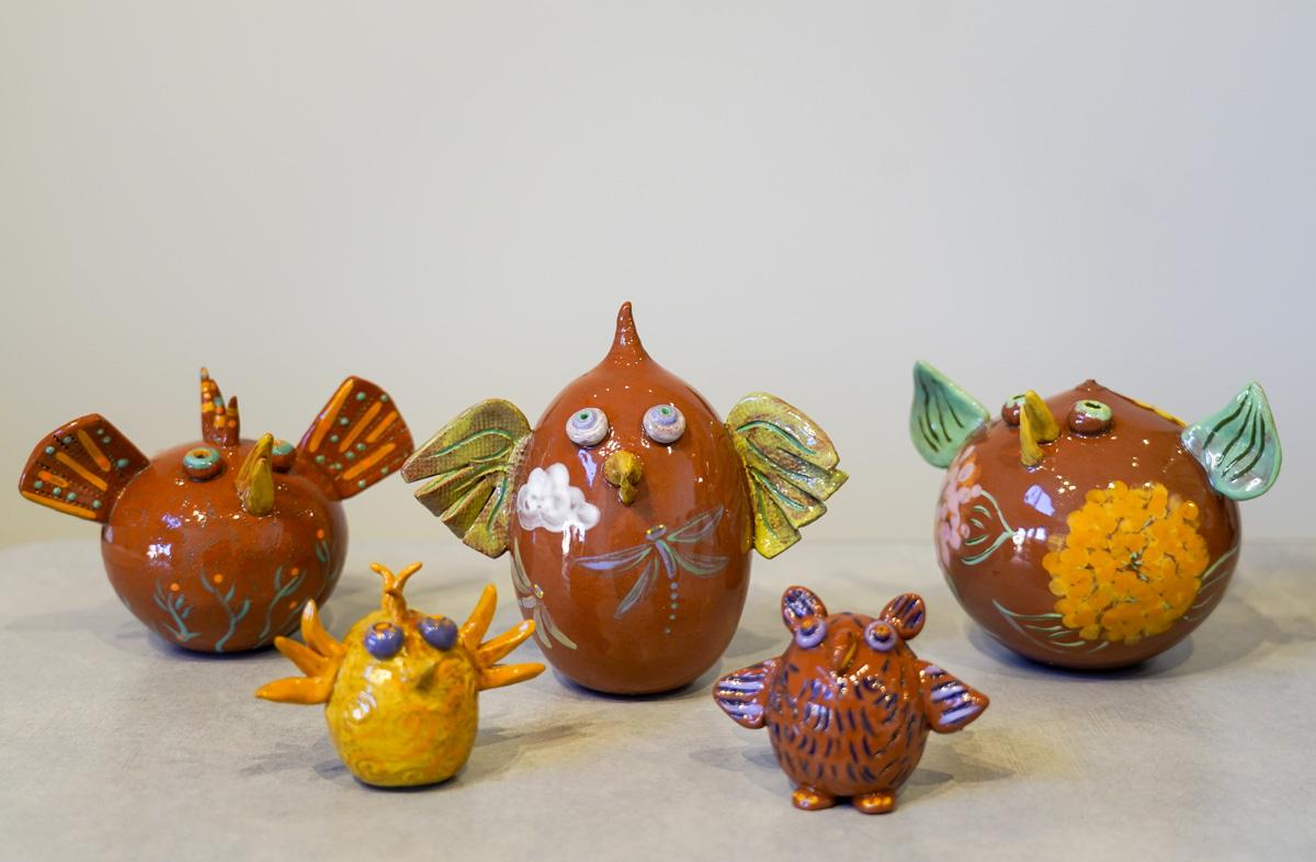 a collection of ceramic birds